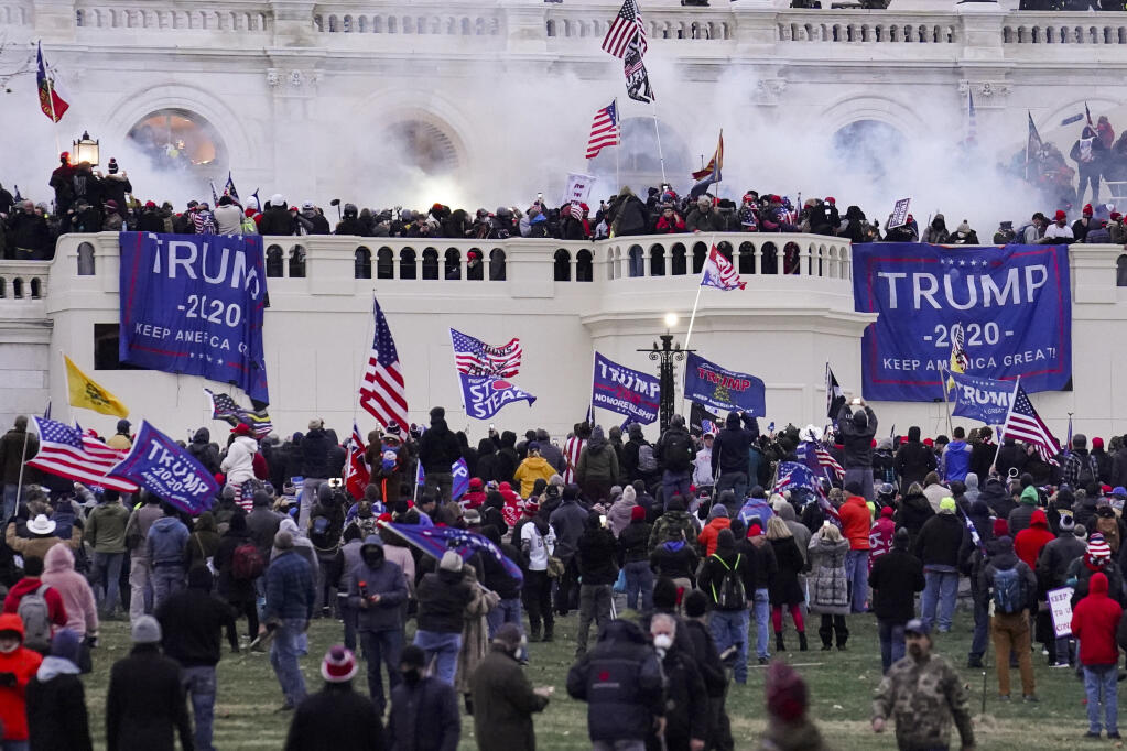 Violent rioters, loyal to President Donald Trump, storm the Capitol on Jan. 6. (JOHN MINCHILLO / Associated Press)