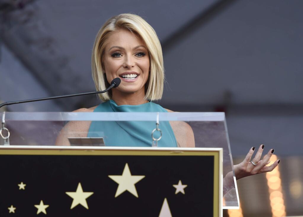 FILE - In this Oct. 12, 2015 file photo, Kelly Ripa addresses the crowd during a ceremony honoring her with a star on the Hollywood Walk of Fame in Los Angeles. Ripa is returning to her daytime talk show, ending an absence that followed word her co-host, Michael Strahan, will join 'Good Morning America.' She will be back Tuesday, April 26, 2016 on 'Live With Kelly and Michael,' she said in an email to the show's staff that was obtained by The Associated Press.(Photo by Chris Pizzello/Invision/AP)
