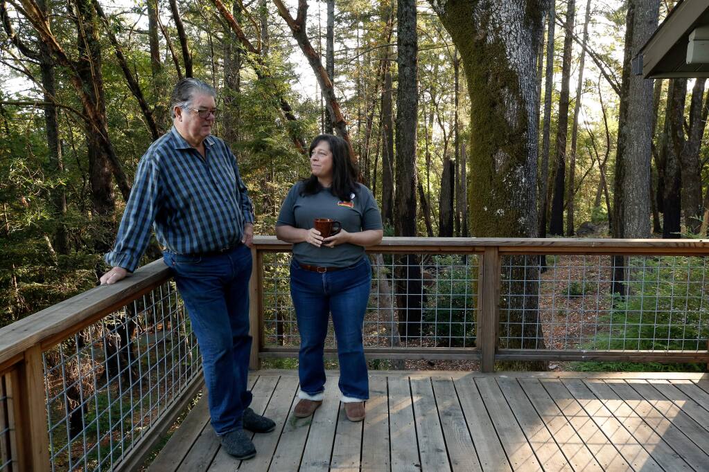Brad and Lisa Warner stand on the side of their home where flames of the Nuns Fire came closest to their house in 2017, before they participate in a fire evacuation drill for residents of the Cavedale-Trinity community, near Glen Ellen, California, on Saturday, August 24, 2019. This fire evacuation drill is the first of its kind in Sonoma County. (Alvin Jornada / The Press Democrat)
