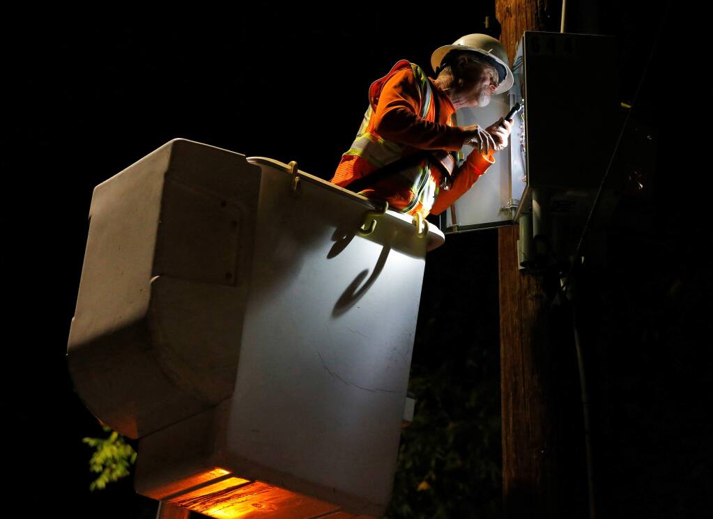 A PG&E crew works to re-energize power lines along Middle Rincon Road after the public safety power shutoff in Santa Rosa on Thursday, Oct. 10, 2019. (Alvin Jornada / The Press Democrat)