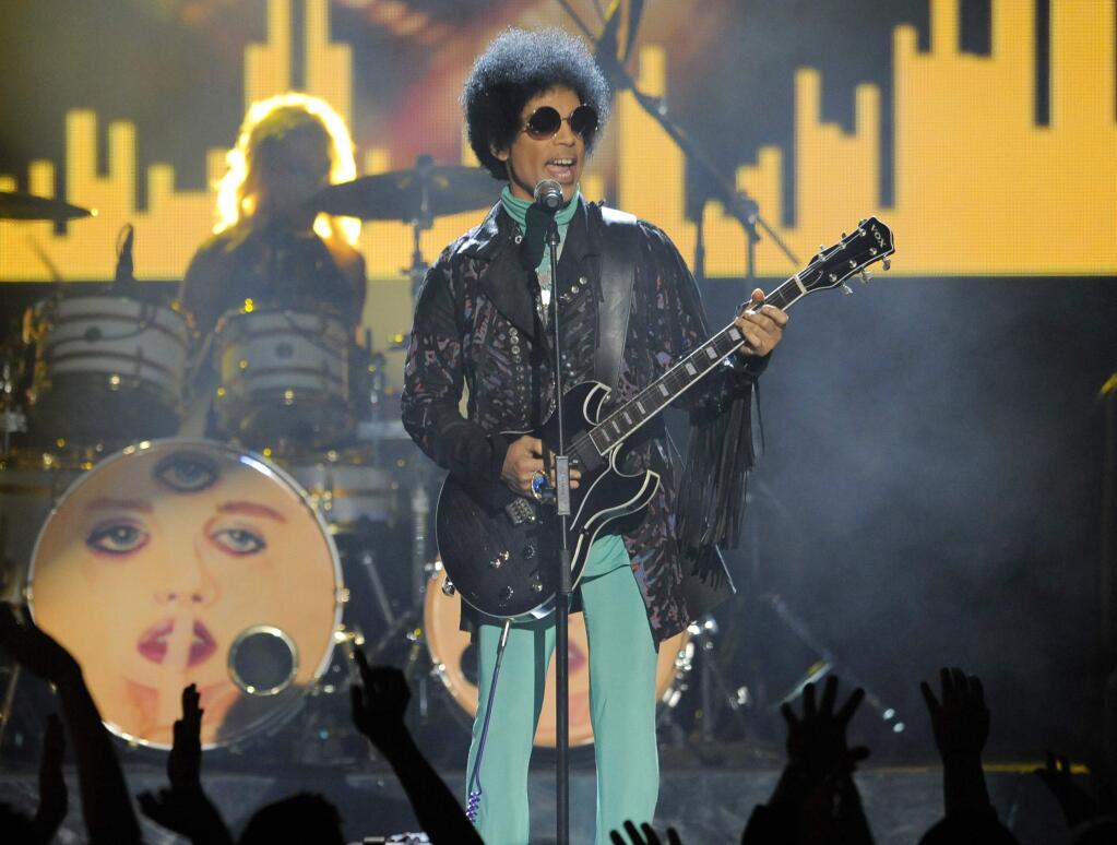 FILE - In this May 19, 2013 file photo, Prince performs at the Billboard Music Awards at the MGM Grand Garden Arena in Las Vegas. Mariah Brown, a former assistant to Prince until last year, has spent the days since his death trying to figure out how her boss, could have died so suddenly, adding that she never saw the singer ingest any substances during her employ. Prince was found dead at his home on April 21, 2016, in suburban Minneapolis. He was 57 (Photo by Chris Pizzello/Invision/AP, File)