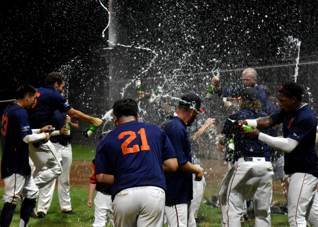The Sonoma Stompers pop the bubbly to celebrate their clinch of first place in the 2019 Pacific Association season, their fifth consecutive post-eason appearance. The playoffs begin for the top-seeded Stomers on Friday, Aug. 30, when they open a best-of-three series at home against whoever survives the first two playoff games. (James W. Toy III / Stompers Baseball)