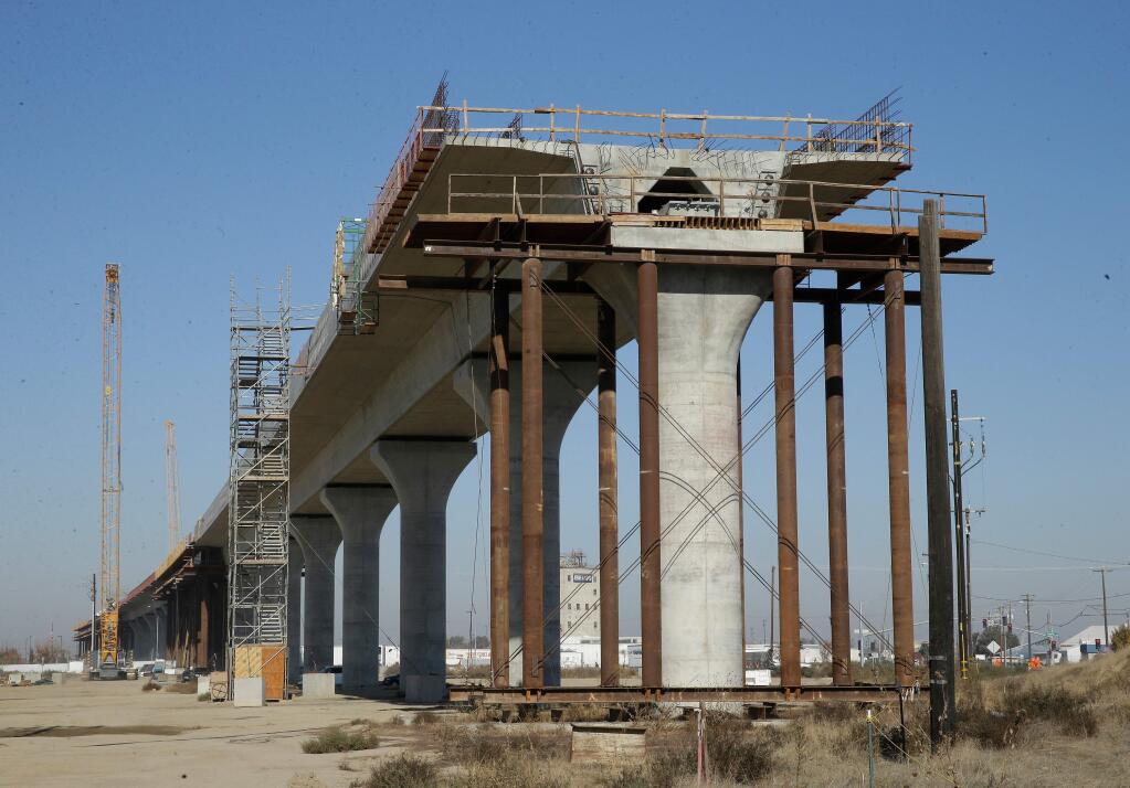 FILE - This Dec. 6, 2017 file photo shows one of the elevated sections of the high-speed rail under construction in Fresno, Calif. High-speed rail executives are urging skeptical lawmakers to provide more long-term funding for the bullet train in the face of ballooning costs. (AP Photo/Rich Pedroncelli, File)
