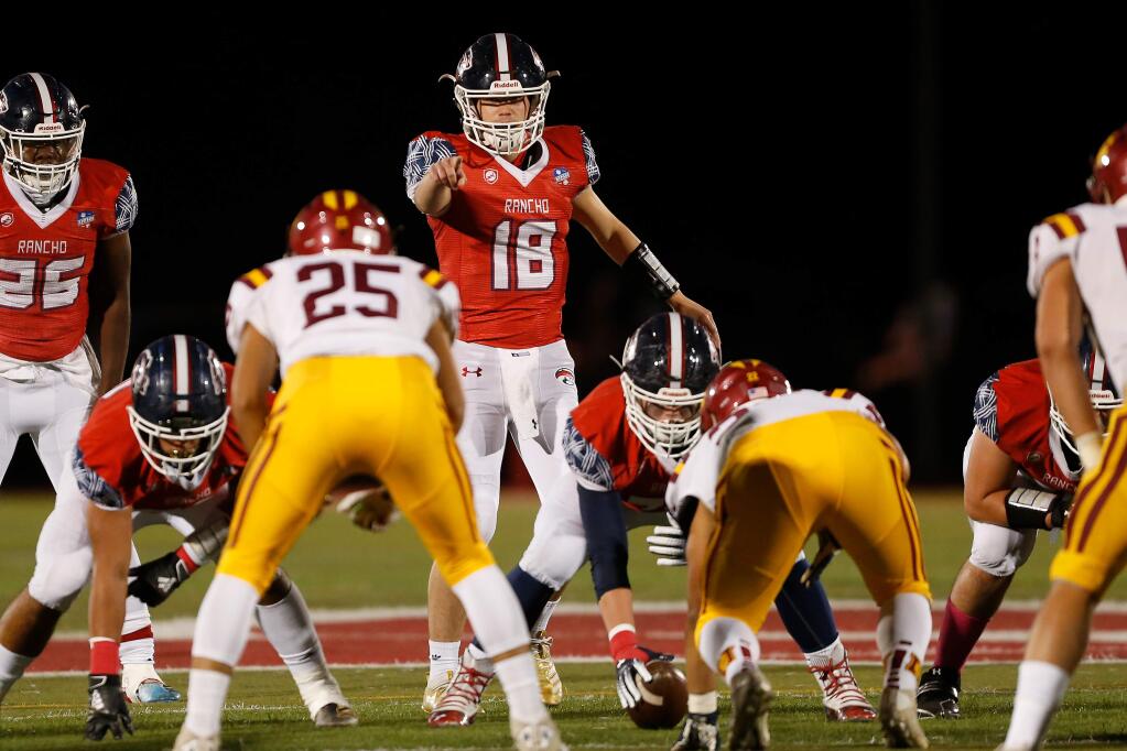 Rancho Cotate quarterback Jared Stocker directs attention to Cardinal Newman's Santino Acevedo during the first half in Rohnert Park on Friday, Oct. 4, 2019. (Alvin Jornada / The Press Democrat)