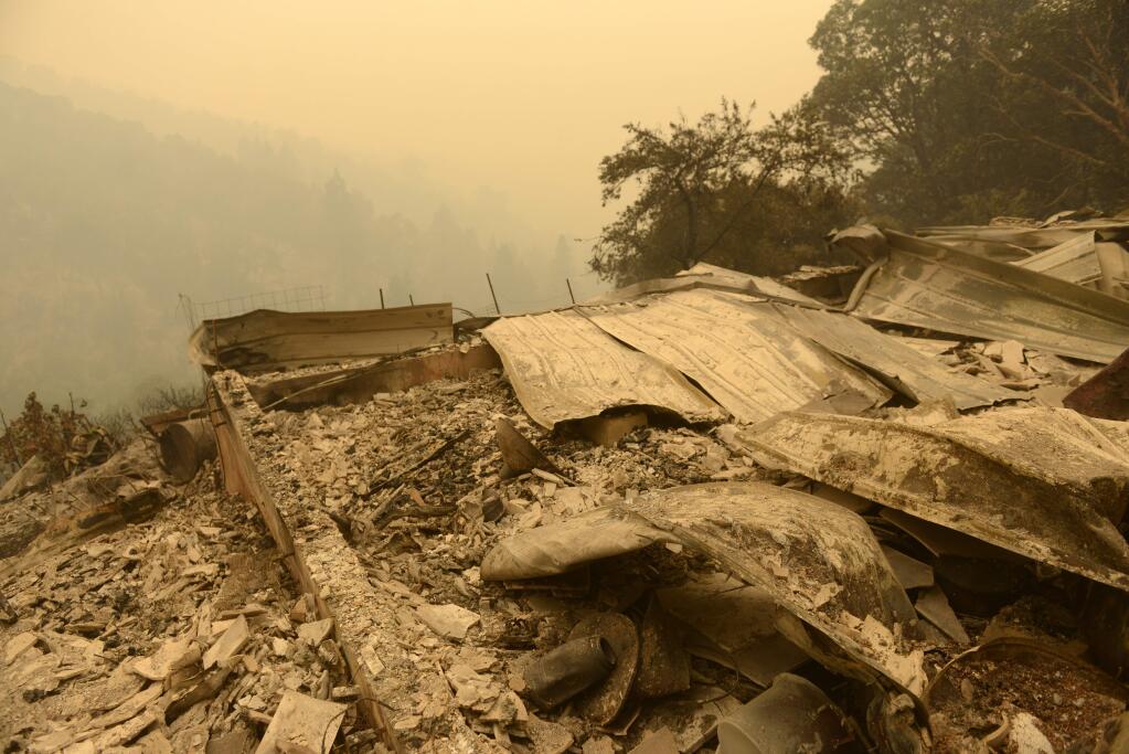 Smoke surrounds the ruins of a home that was destroyed by the Soberanes Fire in Palo Colorado Canyon on the northern Big Sur Coast on Tuesday July 26, 2016 in Big Sur, Calif. California's signature parks along the Big Sur coastline that draw thousands of daily visitors were closed Tuesday as one of the state's two major wildfires threatened the scenic region at the height of the summer tourism season. (David Royal/The Monterey County Herald via AP)