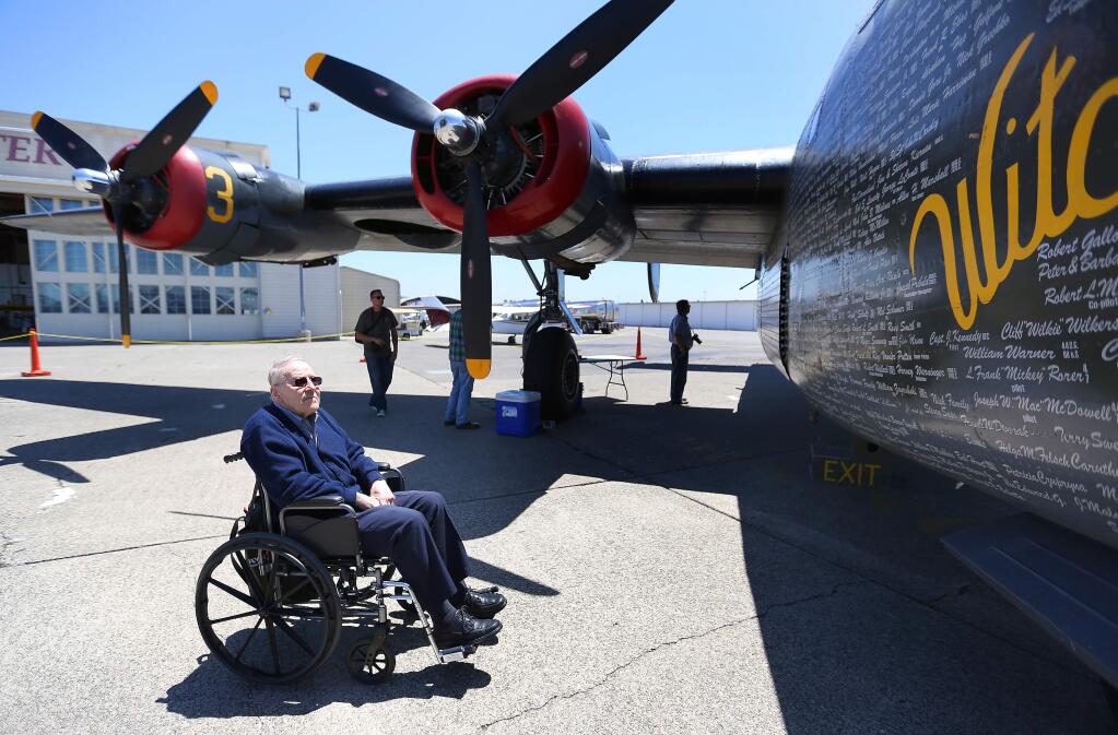 Jack Eshe of Santa Rosa checks a B24 WWII plane that was on display at the Charles M. Schulz-Sonoma County Airport, Wednesday, May 27, 2015. Eshe, flew a B-17 in WWII. (CRISTA JEREMIASON / The Press Democrat)