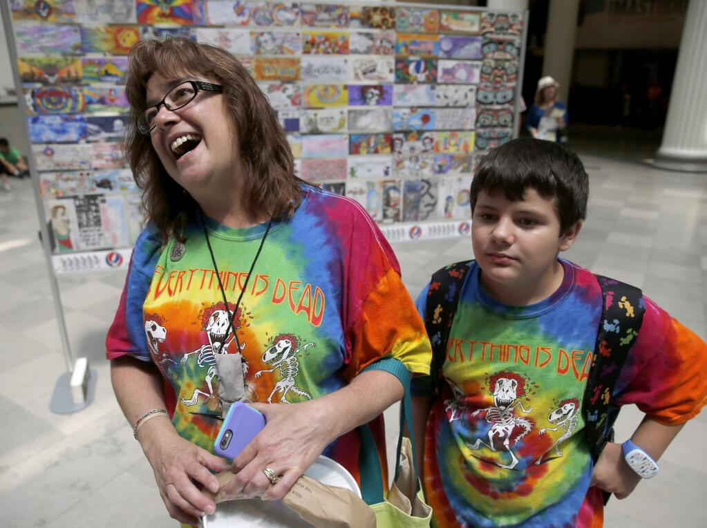 In this Tuesday, June 30, 2015, photo, Rebecca Ostrega, from Oswego, Ill., talks about her devotion to the Grateful Dead as she and her son Jake, visit an exhibit dedicated to the band at the Field Museum in Chicago. The Dead are scheduled to perform multiple shows over the July 4th weekend at Soldier Field. (AP Photo/Charles Rex Arbogast)