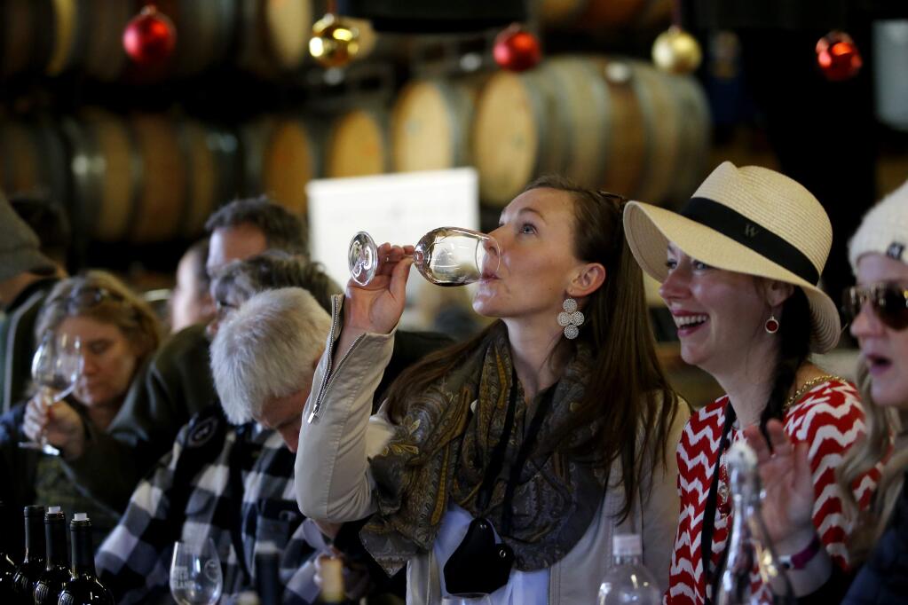 Friends Mary Naden, center, and Rhea Nelson right, drink wine at Hook and Ladder Winery during the Winter WINEland event in Santa Rosa, on Saturday, January 14, 2017. (BETH SCHLANKER/ The Press Democrat)