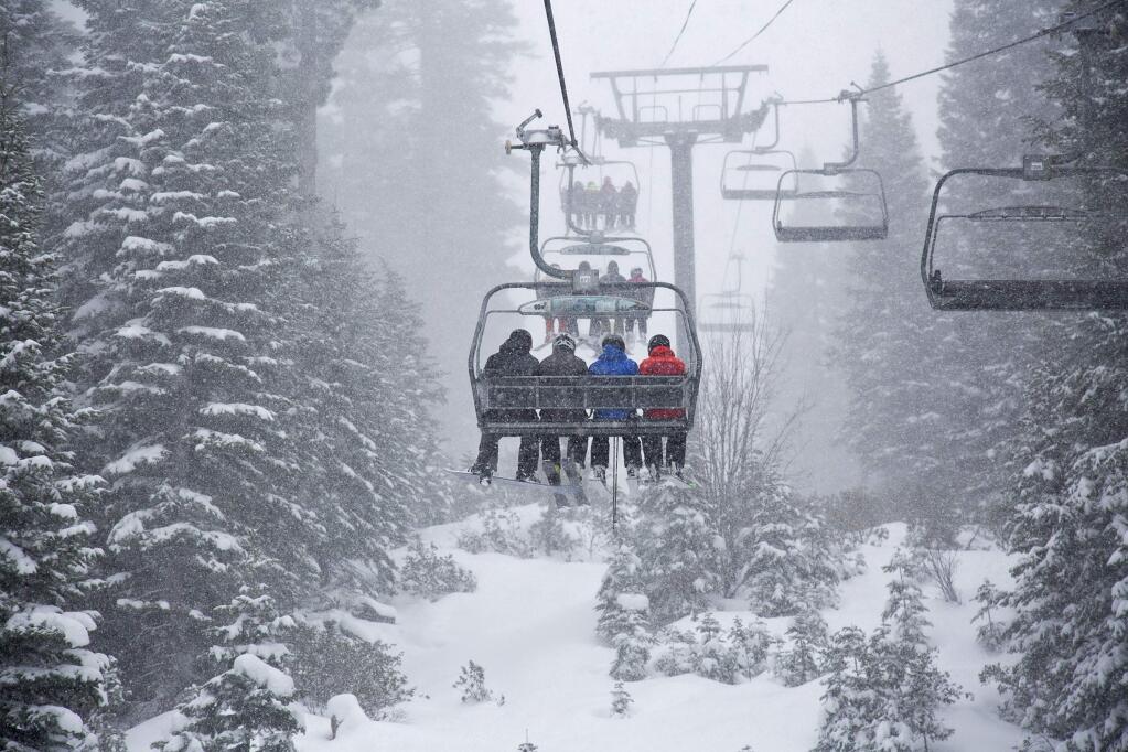 In this photo provided by Northstar California, skiers ride a chair lift as snow falls Thursday, March 1, 2018, at the Northstar California resort in Truckee, Calif. (Northstar California via AP)