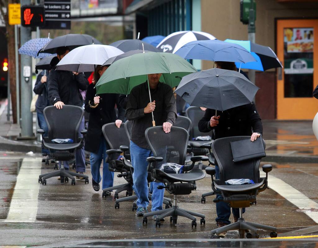 Employees of TLCD Architecture paraded their office chairs and plants from their old offices on Santa Rosa Ave to the 2nd floor of the Museum on the Square building in downtown Santa Rosa. (JOHN BURGESS / The Press Democrat)