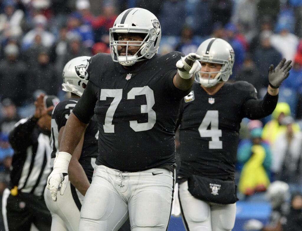 Oakland Raiders guard Marshall Newhouse, left, and quarterback Derek Carr indicate a penalty on the defense during the second half against the Buffalo Bills, Sunday, Oct. 29, 2017, in Orchard Park, N.Y. Buffalo beat Oakland 34-14. (AP Photo/Adrian Kraus)