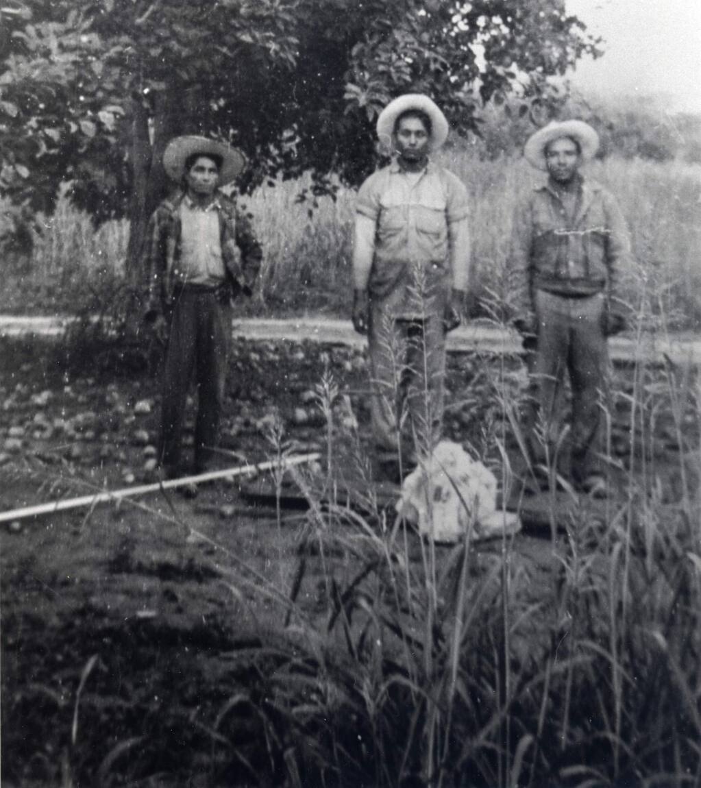 A trio of braceros, among the earliest Mexican workers in the area, pose in a Windsor field in the early 1940s. (Photo courtesy Morales family)