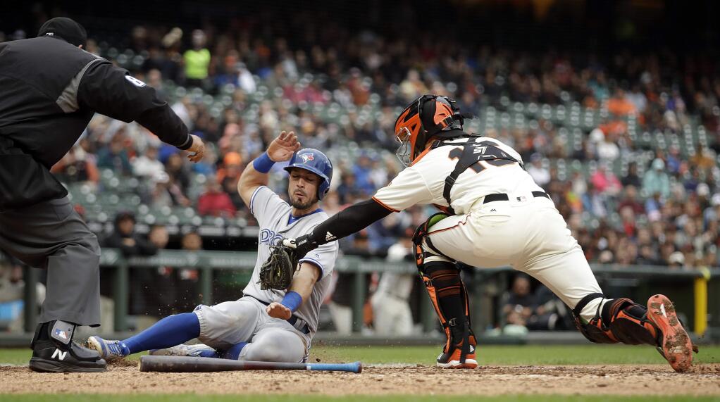 San Francisco Giants catcher Aramis Garcia, right, tags out Toronto Blue Jays' Randal Grichuk at home plate in the sixth inning of a baseball game Wednesday, May 15, 2019, in San Francisco. Grichuk was out on the double play while attempting to score on a hit by Toronto's Billy McKinney. (AP Photo/Ben Margot)