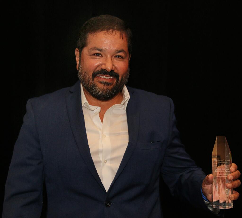 Mike Lopez of Vantreo Insurance Brokerage accepts one of North Bay Business Journal's Latino Business Leadership Awards, held at Hyatt Regency Sonoma Wine Country on Oct. 27, 2017. (JEFF QUACKENBUSH / NORTH BAY BUSINESS JOURNAL)