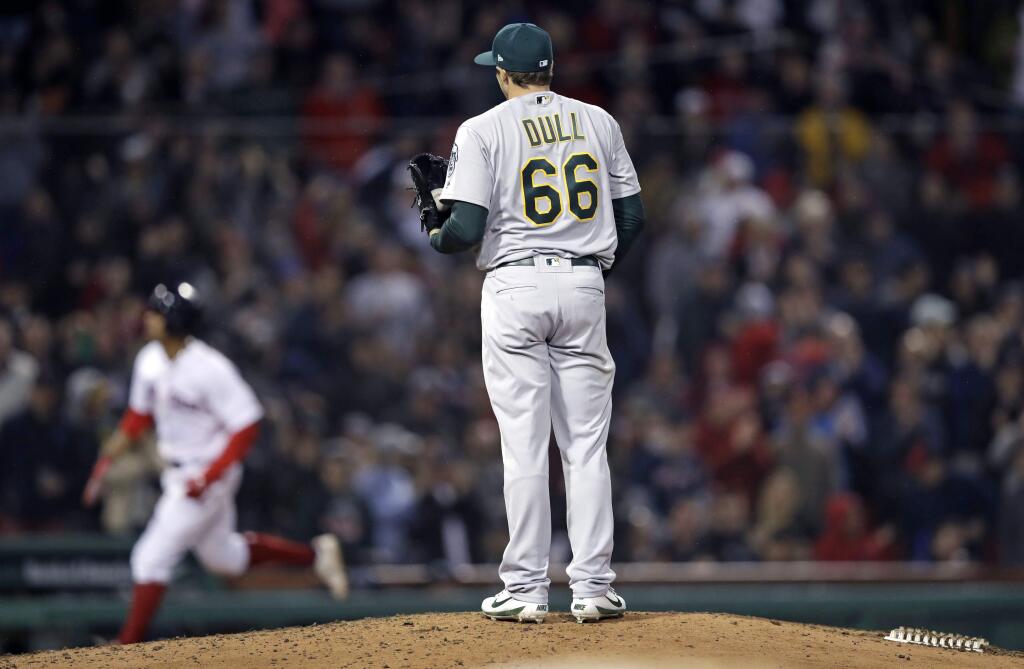 Oakland Athletics relief pitcher Ryan Dull waits for Boston Red Sox's Xander Bogaerts to run the bases on a three-run home run during the sixth inning at Fenway Park in Boston, Wednesday, May 16, 2018. (AP Photo/Charles Krupa)