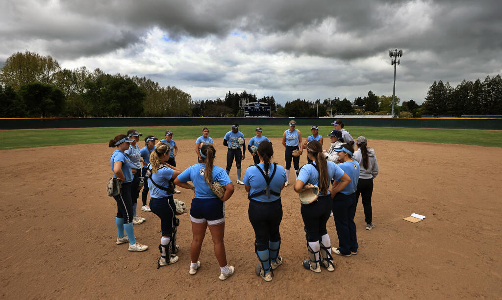 Sonoma State University’s softball team gathers for a team meeting, Tuesday, May 2, 2023, during practice on the SSU campus in Rohnert Park. (Kent Porter / The Press Democrat)