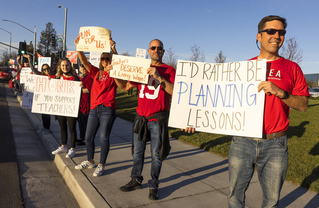 Teachers, parents and students protest for increased wages in front of Rancho Cotate High School in Rohnert Park where the school board was meeting on Tuesday, March 8, 2022.  (Photo by John Burgess/The Press Democrat)