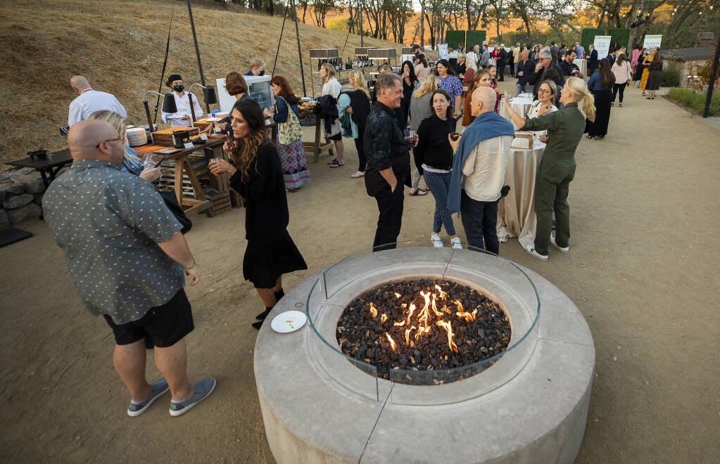 Guests headed up to an upper terrace for more food, wine and a look at auction items at the 2021 Sonoma County Wine Auction weekend kick off party at Montage Healdsburg on Thursday, Sept. 16, 2021. (John Burgess/The Press Democrat)
