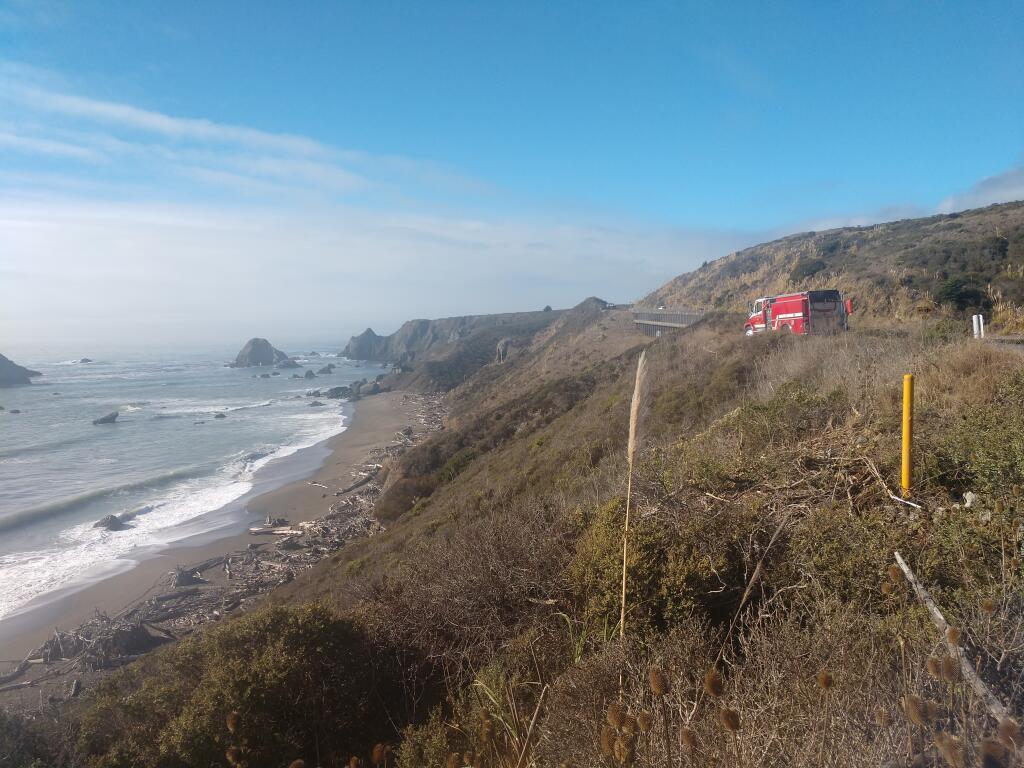 A fire truck sits parked Sunday afternoon along Highway 1 north of Jenner as first responders work to rescue a man who drove his SUV off the road, crashing it 200 feet below on Driftwood Beach. (Pat Paterson)