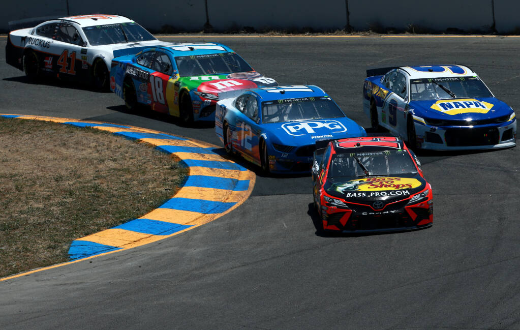SONOMA, CALIFORNIA - JUNE 23: Martin Truex Jr., driver of the #19 Bass Pro Shops Toyota, leads a pack of cars during the Monster Energy NASCAR Cup Series Toyota/Save Mart 350 at Sonoma Raceway on June 23, 2019 in Sonoma, California. (Photo by Sean Gardner/Getty Images)