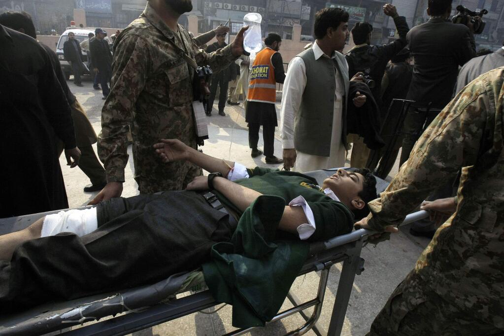 A Pakistani student, who was injured in a Taliban attack in a school, is wheeled into a hospital in Peshawar, Pakistan,Tuesday, Dec. 16, 2014. Taliban gunmen stormed a military-run school in the northwestern Pakistani city of Peshawar on Tuesday, killing and wounding scores, officials said, in the highest-profile militant attack to hit the troubled region in months.(AP Photo/Mohammad Sajjad)