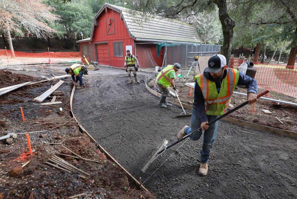 A construction crew works on accessibility alterations to the pathways at Howarth Park in Santa Rosa on Monday, January 13, 2020. (Christopher Chung/ The Press Democrat)