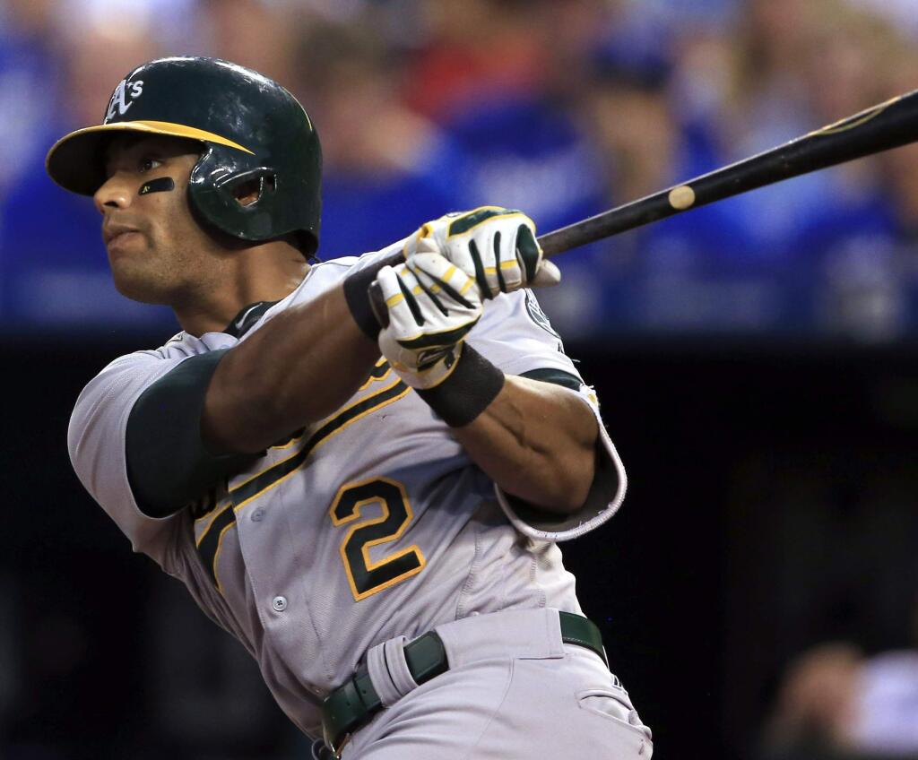 In this Sept. 15, 2016, file photo, the Oakland Athletics' Khris Davis hits a two-run double off Kansas City Royals starting pitcher Edinson Volquez during the fourth inning in Kansas City, Mo. (AP Photo/Orlin Wagner, File)