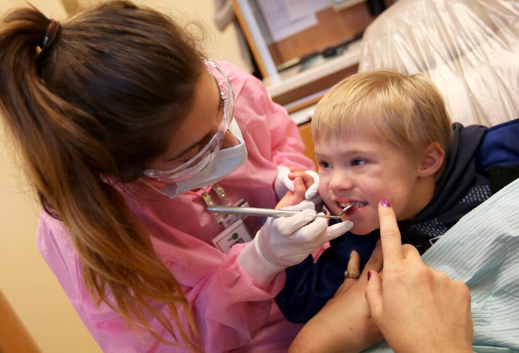 12/21/2014:B1:Lauren Katzel checks the teeth of Benjamin Leeburg, 4, at Petaluma Health Centerís dental clinic Friday. A new report on dental care for children blasts the California Department of Health Care Services, which is responsible for administering Medi-Cal.CRISTA JEREMIASON / The Press DemocratPC:Lauren Katzel checks the teeth of Benjamin Leeburg, 4, at Petaluma Health Center's dental clinic, Friday, December 19, 2014. (Crista Jeremiason / The Press Democrat)