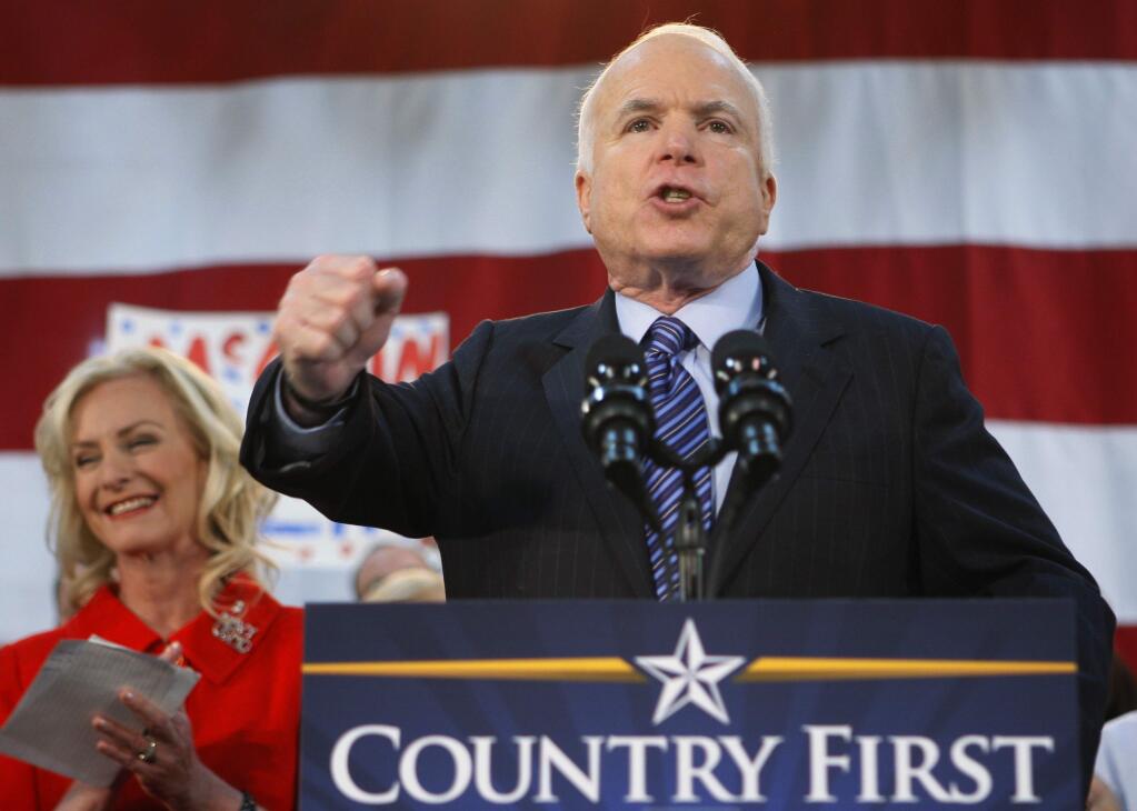 FILE - In this Oct. 21, 2008 file photo, Republican presidential candidate Sen. John McCain, R-Ariz., standing with his wife Cindy, encourages his supporters to stand up and fight for America at the close of his address during a campaign rally in Bensalem, Pa. McCain's family says the Arizona senator has chosen to discontinue medical treatment for brain cancer. (AP Photo/Stephan Savoia)