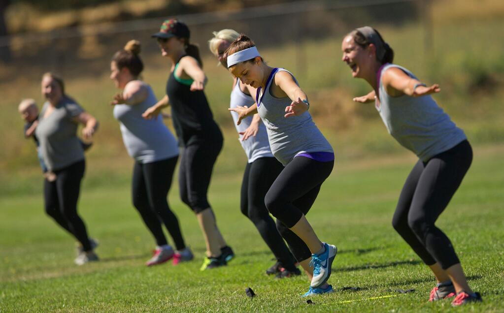 Marisa Stack, right, leads a group of mothers in a workout with RunMama Fitness at Galvin Park in Santa Rosa on Friday. (photo by John Burgess/The Press Democrat)