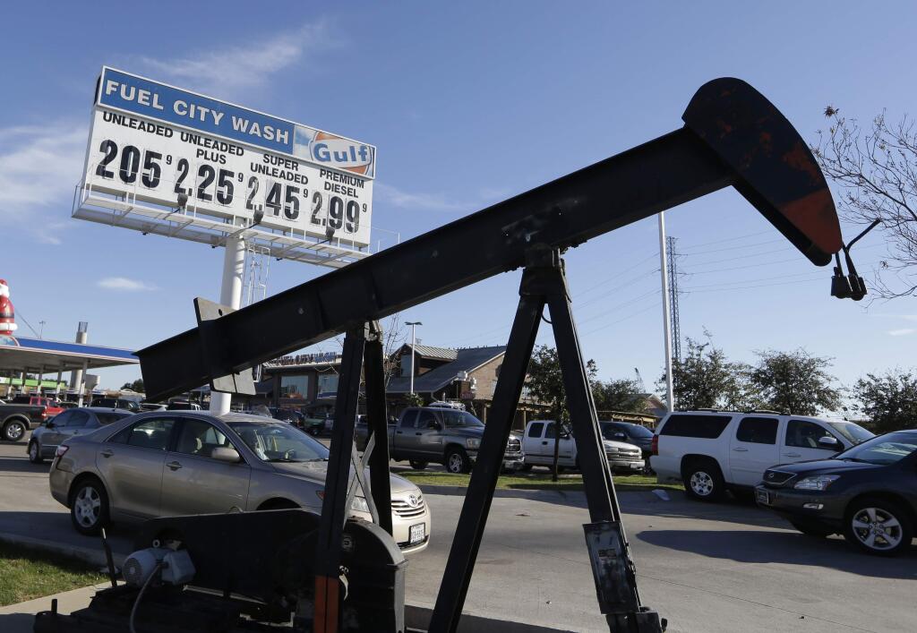FILE - In this Dec. 15, 2014 file photo, vehicles line up to take advantage of low gas prices at the Fuel City gas station in Dallas. The collapse of oil prices this year has become a huge topic of worry and comfort for investors. (AP Photo/LM Otero, File)