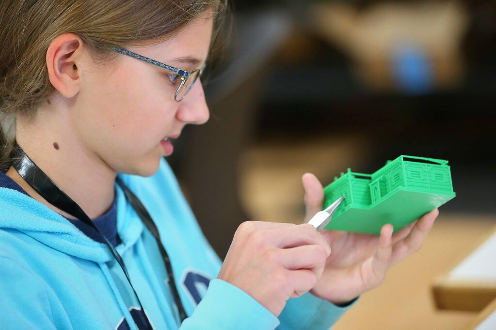 Aliyah Smith, 13, works on a 3D printed model house for an arena she is building for robots during the Girls Tinker Academy at Sonoma State University, in Rohnert Park on Tuesday, July 30, 2019. (Christopher Chung/ The Press Democrat)