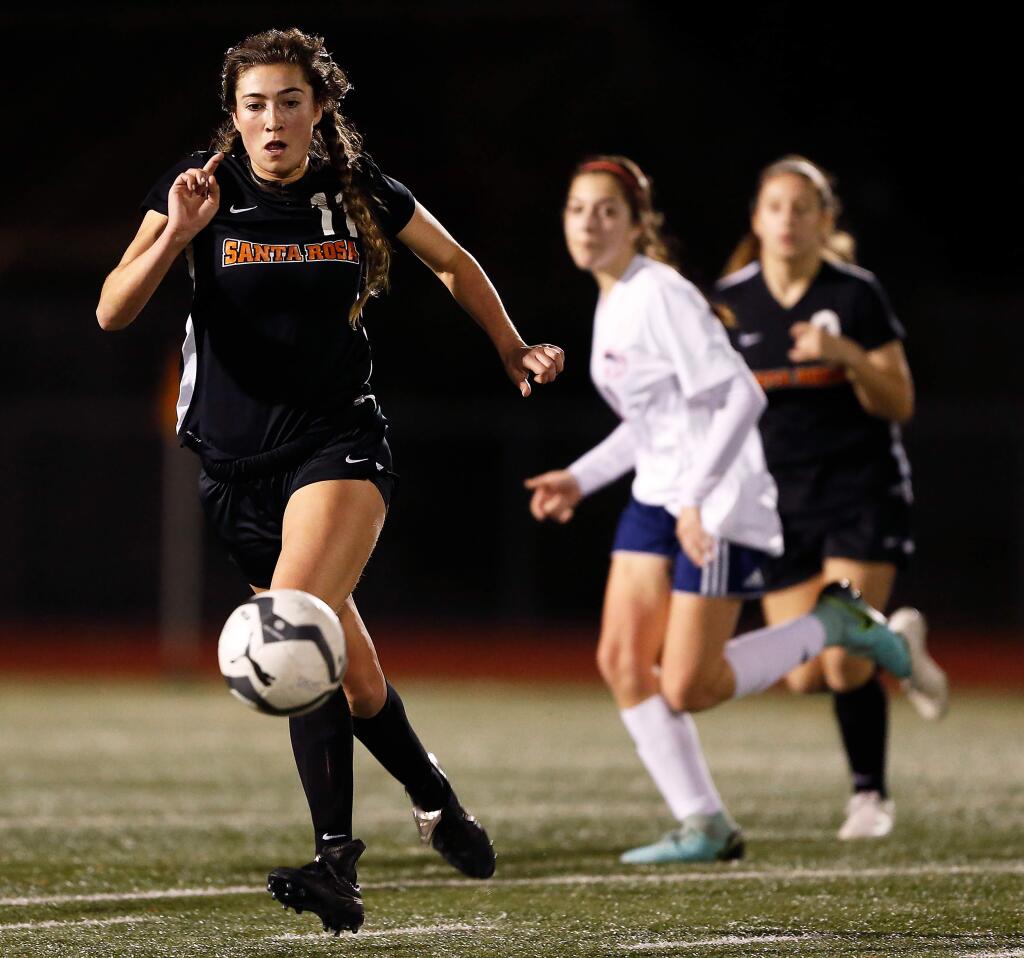 Santa Rosa's Anika Williams, left, dribbles the ball across midfield during the first half of a soccer game between Rancho Cotate and Santa Rosa high schools in Santa Rosa on Tuesday, January 22, 2019. (Alvin Jornada / The Press Democrat)