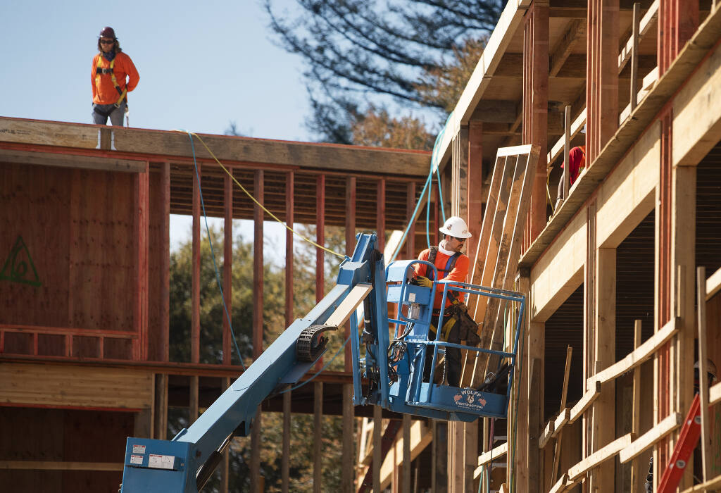Workers install framing for columns in the 54-unit Sage Commons affordable housing project on the corner of College and Cleveland avenues in Santa Rosa on Tuesday, March 23, 2021. The project, along with the 46-unit Boyd Street Family Apartments, is being built by Danco Communities of Humboldt County. (John Burgess / The Press Democrat)