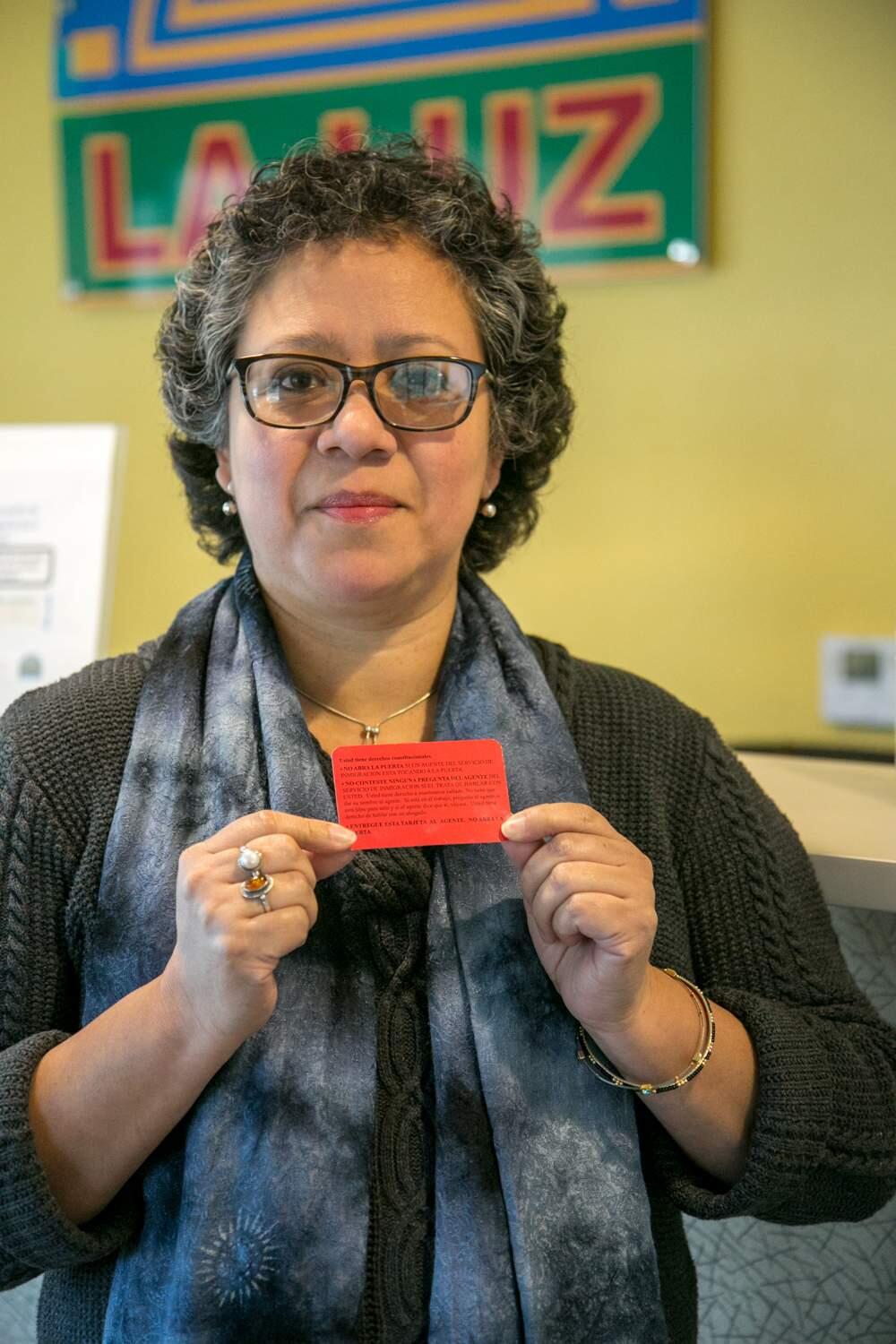 Patricia Galindo, Client Services Coordinator for La Luz Center, holds the red card explaining constitutional rights in English and Spanish, available at the center in Sonoma, Feb. 23, 2017. (Photo by Julie Vader/Special to the Index-Tribune)