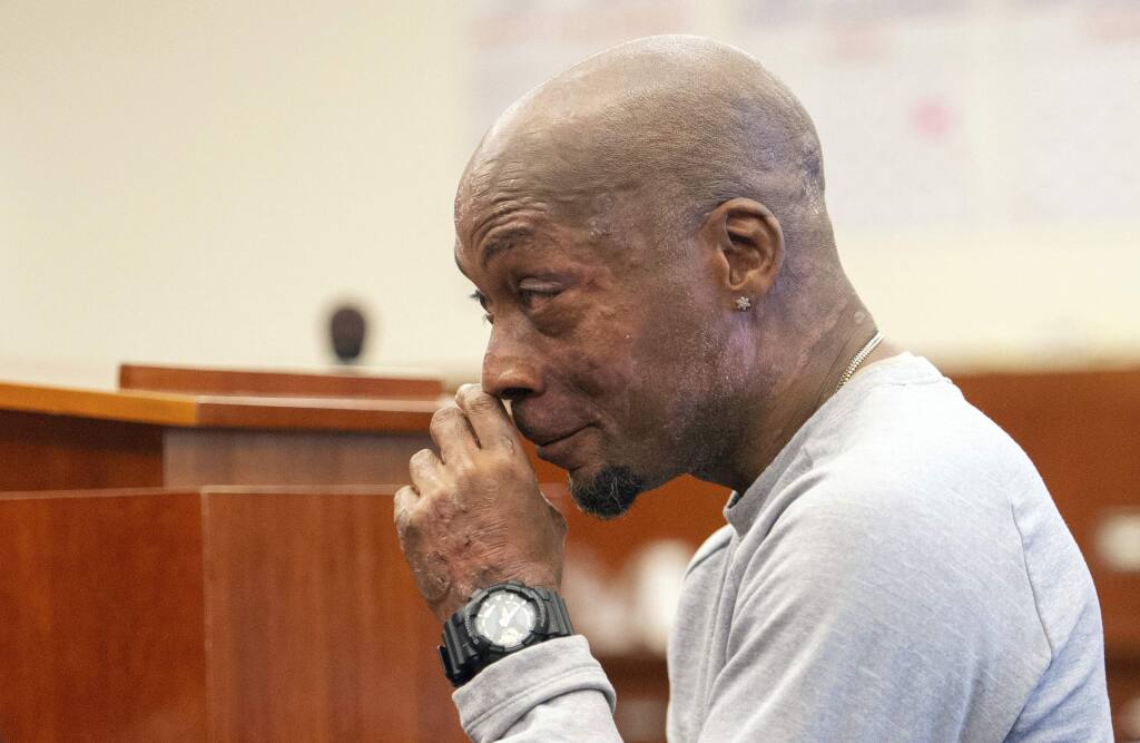 FILE - In this Aug. 10, 2018 file photo, Dewayne Johnson reacts after hearing the verdict in his case against Monsanto at the Superior Court of California in San Francisco. Jurors who found that agribusiness giant Monsanto's Roundup weed killer contributed to the school groundskeeper's cancer are urging a San Francisco judge not to throw out the bulk of their $289 million award in his favor, a newspaper reported Monday, Oct. 15. (Josh Edelson/Pool Photo via AP, File)