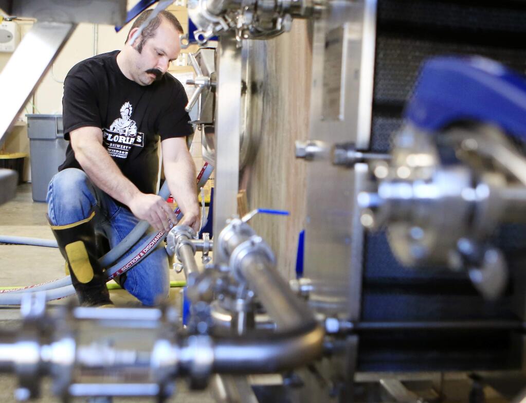 -Owner Aron Levin cleans the tanks at his St. Florian's Brewery shortly after it opened in 2013.