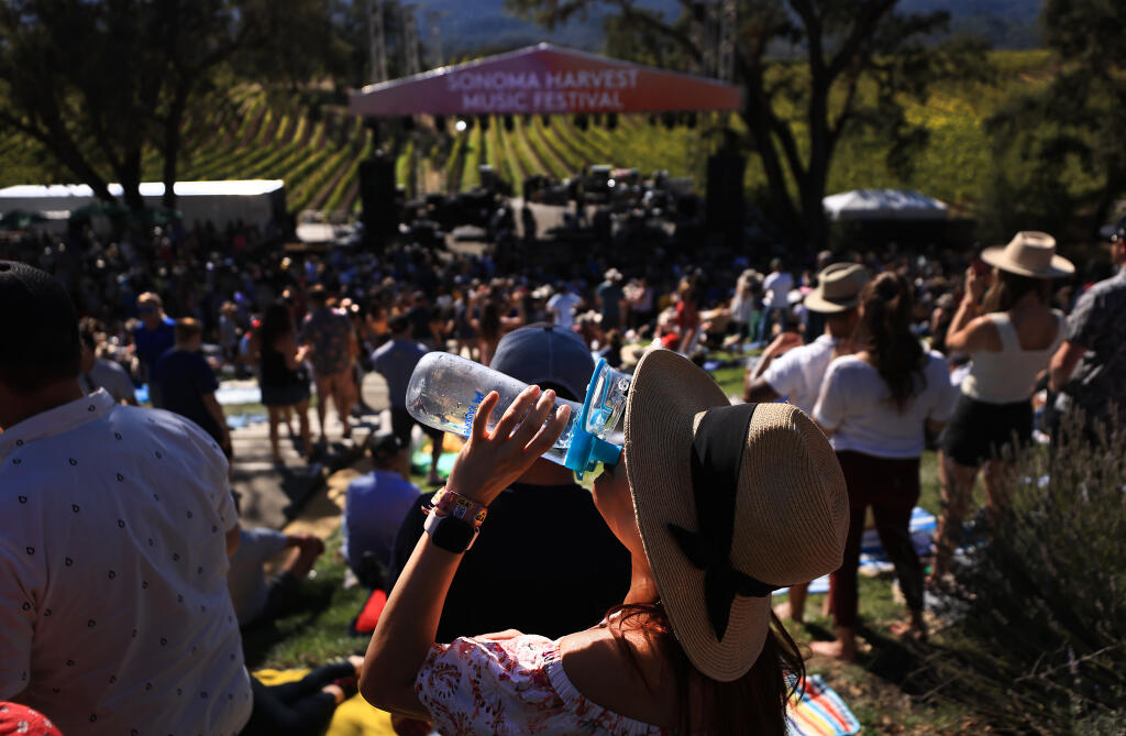 Saturday afternoons summer like heat had those attending the  Sonoma Harvest Music Festival hydrate at B.R. Cohn Winery and Olive Oil Company, Saturday, Oct. 8, 2022, in Glen Ellen.  (Kent Porter / The Press Democrat) 2022