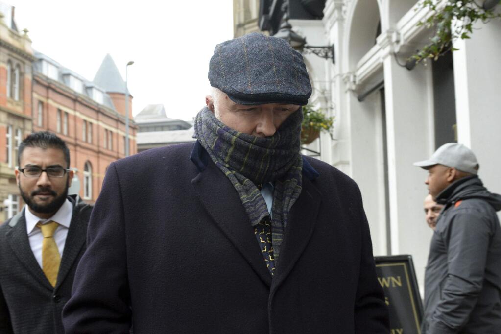 Specialist surgeon Simon Bramhall leaves Birmingham Crown Court in Birmingham, England, Friday, Jan. 12, 2018. A British surgeon who burned his initials into patients' livers during transplant operations has been fined 10,000 pounds ($13,600) and ordered to perform community service. Simon Bramhall pleaded guilty last month to two counts of assault, in a case a prosecutor called 'without legal precedent in criminal law.' (Joe Giddens/PA via AP)