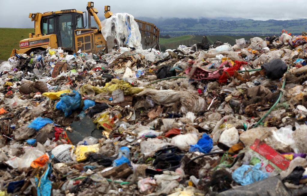 A bulldozer arranges garbage for a compactor at the Sonoma County landfill off Mecham Road. (CHRISTOPHER CHUNG/ PD FILE, 2013)