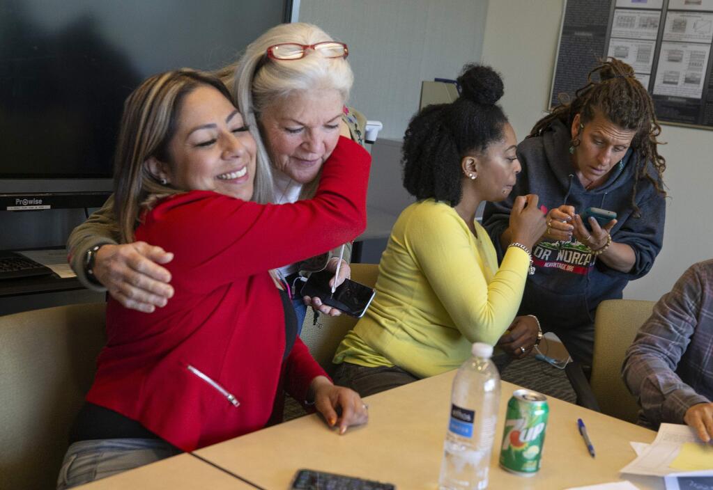 From left, Elizabeth Quiroz, the president of the Second Chance Club, hugs Kate Fielding at the end of their weekly meeting while Constance Tanner and Lisa Aldana exchange information at the end of the weekly meeting o formerly incarcerated Santa Rosa Junior College students. (photo by John Burgess/The Press Democrat)