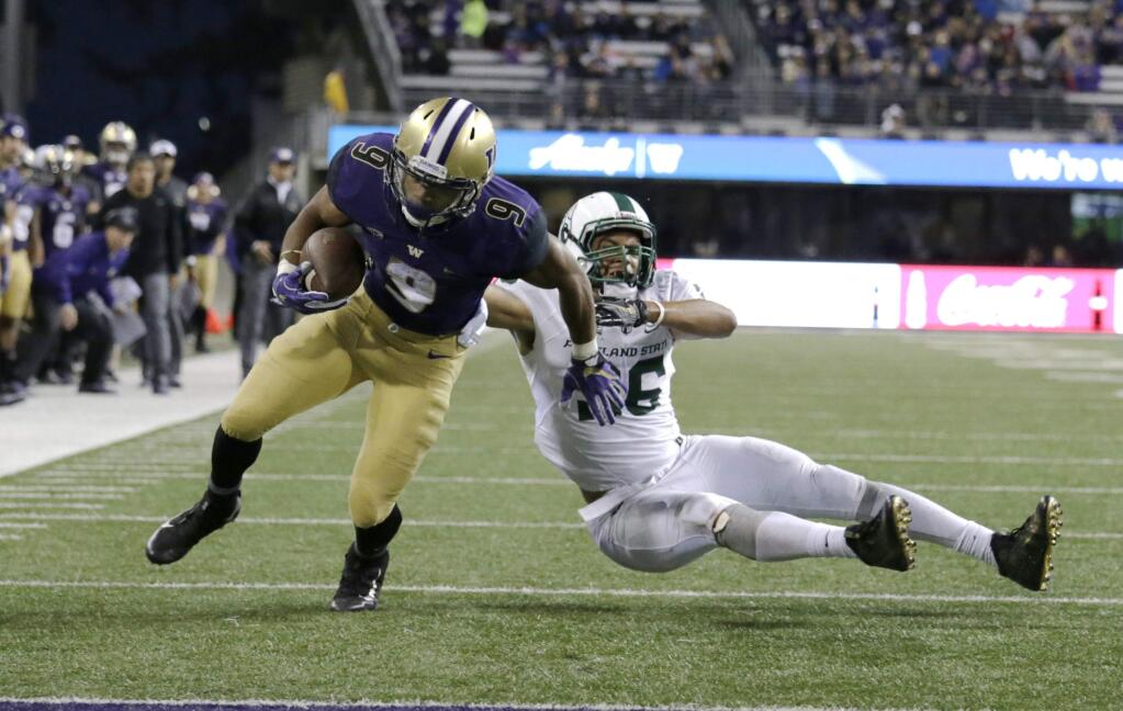 Washington running back Myles Gaskin runs to the end zone for a touchdown evading Portland State defensive end Sam Bodine in the second half of an NCAA college football game, Saturday, Sept. 17, 2016, in Seattle. Washington won 41-3. (AP Photo/John Froschauer)