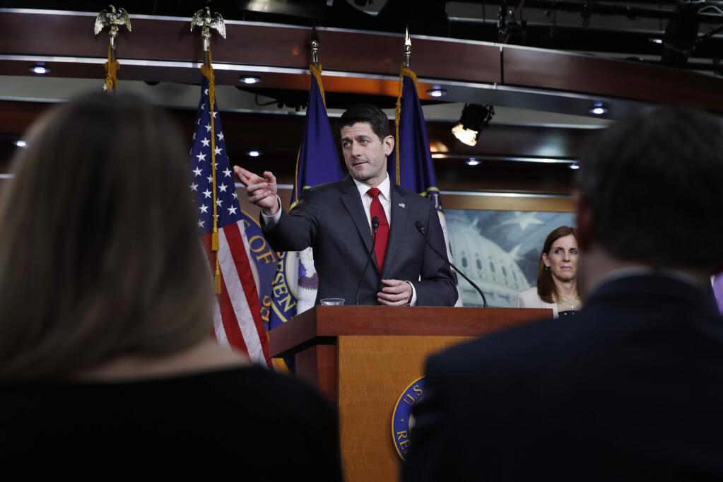 House Speaker Paul Ryan of Wis., center, calls on a reporter during a news conference, Thursday, Feb. 8, 2018, on Capitol Hill in Washington. At right is Rep. Martha McSally, R-Ariz. (AP Photo/Jacquelyn Martin)