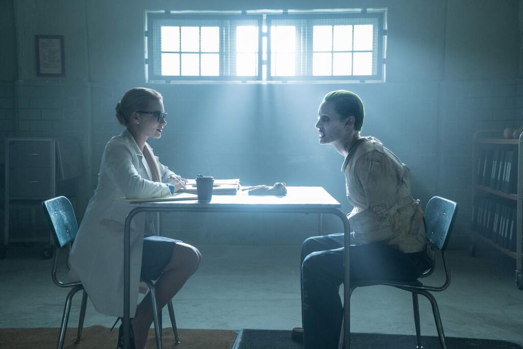 This image released by Warner Bros. Pictures shows Margot Robbie, left, and Jared Leto in a scene from, 'Suicide Squad.' (Clay Enos/Warner Bros. Pictures via AP)