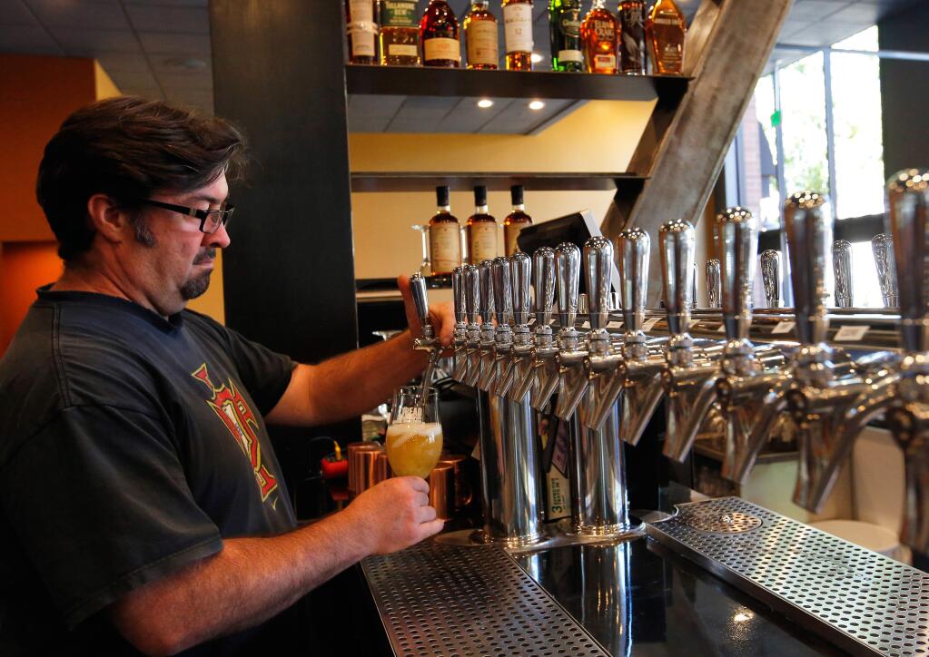 Brewmaster/partner Christian August pours a glass from one of the 16 beers on tap at 2 Tread Brewing Company in Santa Rosa, California, on Tuesday, September 19, 2017. (Alvin Jornada / The Press Democrat)