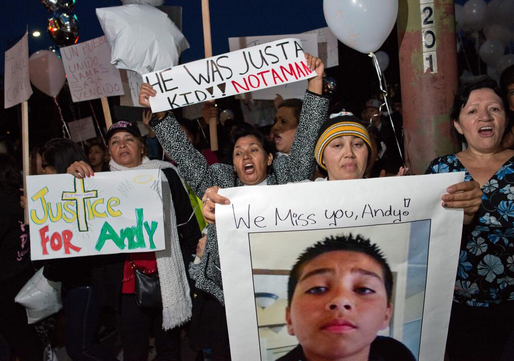 Sujey Lopez, second from right, stands with a large group of protesters in front of Santa Rosa City Hall, at the corner of Santa Rosa Avenue and 1st Street, during a protest march and vigil for Andy Lopez in Santa Rosa, Calif., on Oct. 24, 2013, two days after the 13-year-old was shot and killed by a Sonoma County sheriff's deputy. (ALVIN JORNADA/ PD)