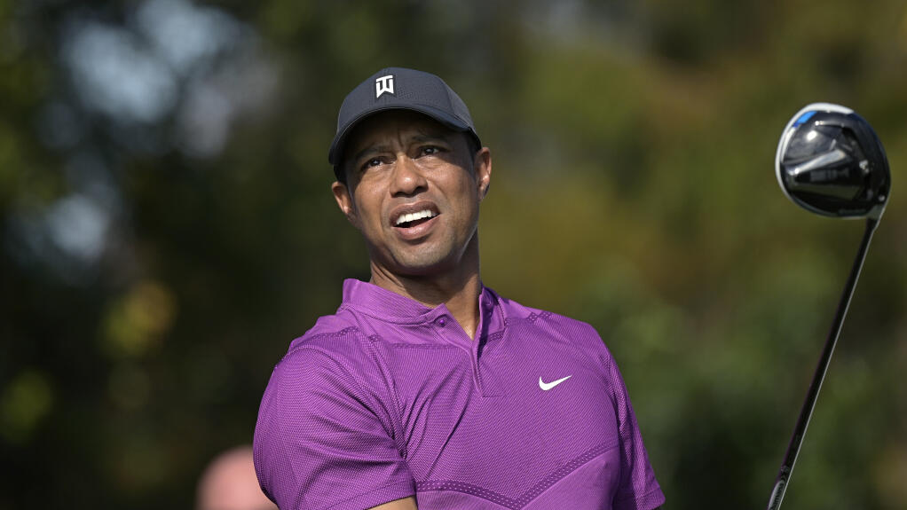 File-This Dec. 19, 2020, file photo shows Tiger Woods watching his tee shot on the first hole during the first round of the PNC Championship golf tournament, in Orlando, Fla. Woods announced Tuesday, Jan. 19, 2021, he had a fifth back surgery and will miss tournaments in San Diego and Los Angeles. (AP Photo/Phelan M. Ebenhack, File)