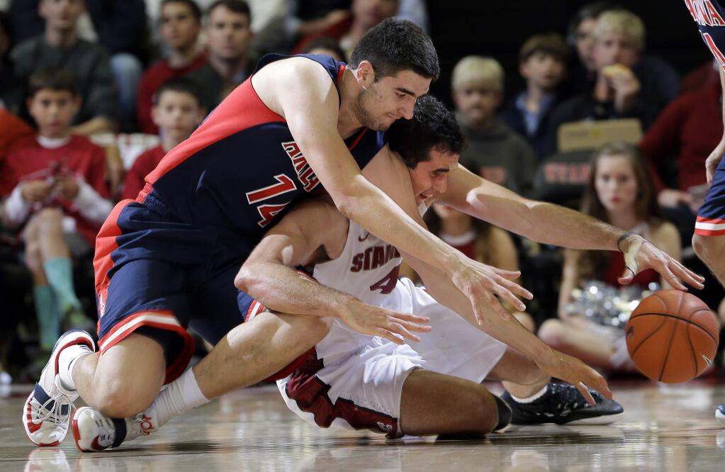 Stanford center Stefan Nastic, right, fights for a loose ball against Arizona center Dusan Ristic (14) during the first half of an NCAA college basketball game Thursday, Jan. 22, 2015, in Stanford, Calif. (AP Photo/Marcio Jose Sanchez)