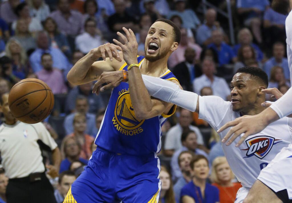Oklahoma City Thunder guard Russell Westbrook, right, knocks the ball away from Golden State Warriors guard Stephen Curry during the second quarter of an NBA basketball game in Oklahoma City, Monday, March 20, 2017. (AP Photo/Sue Ogrocki)