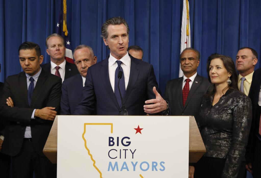 Gov. Gavin Newsom, center discusses the homeless problem facing California after a meeting with the mayors of some of the state's largest cities held at the Governor's office, Wednesday, March 20, 2019, in Sacramento, Calif. Newsom and the mayors are pushing for more money on top of the $500 million the state has already given cities for programs assisting the homeless. Accompanying Newsom are California mayors from left, Robert Garcia, of Long Beach, Kevin Falconer, of San Diego, Darrell Steinberg, of Sacramento, Harry Sidhu of Anaheim, Libby Schaaf, of Oakland and Rusty Bailey, of Riverside, right. (AP Photo/Rich Pedroncelli)